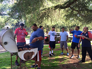 photo of men grilling up chicken at a Gujarati Samaj event.